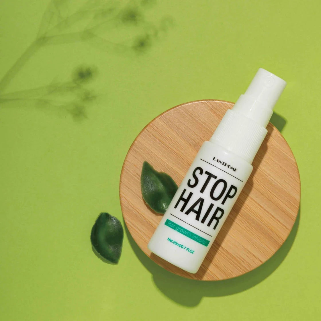 Lanhome Stop Hair spray bottle on green background–rosvia.com